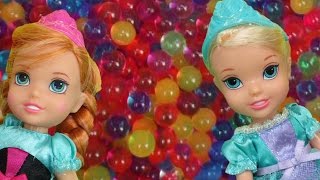 Elsa and Anna toddlers have fun in ORBEEZ  They slide into colorful water beads [upl. by Coben765]