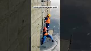 Scaffolders dismantling a hanging scaffold [upl. by Lasorella]