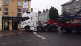 Truck Driver Towing Massive Wind Turbine Expertly Navigates Tiny Irish Town [upl. by Yenruogis531]