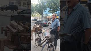 A knife sharpener solicits customers on the street [upl. by Crofoot]