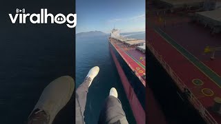 Paramotor Pilot Experiences Sudden Turbulence Over Cargo Ship  ViralHog [upl. by Ainecey427]