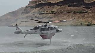 Helicopter picking up water and dropping it on the fire in high winds [upl. by Siloa]