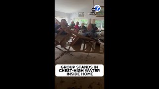 Group stands in chesthigh water inside home [upl. by Worlock]