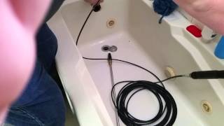 Unclogging a shower drain with a DIY sewer jetting kit [upl. by Otokam]